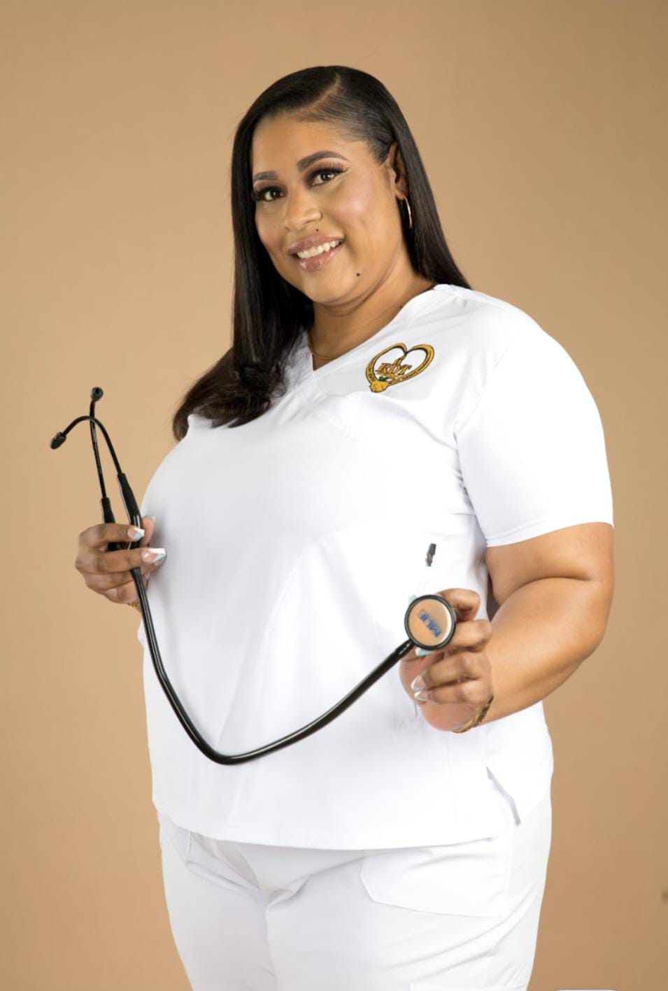 Roxanne McGann, founder of RDT Care Services, smiling with a stethoscope