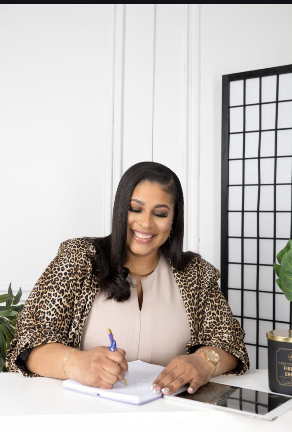 Roxanne McGann, founder of RDT Care Services, writing notes at her desk
